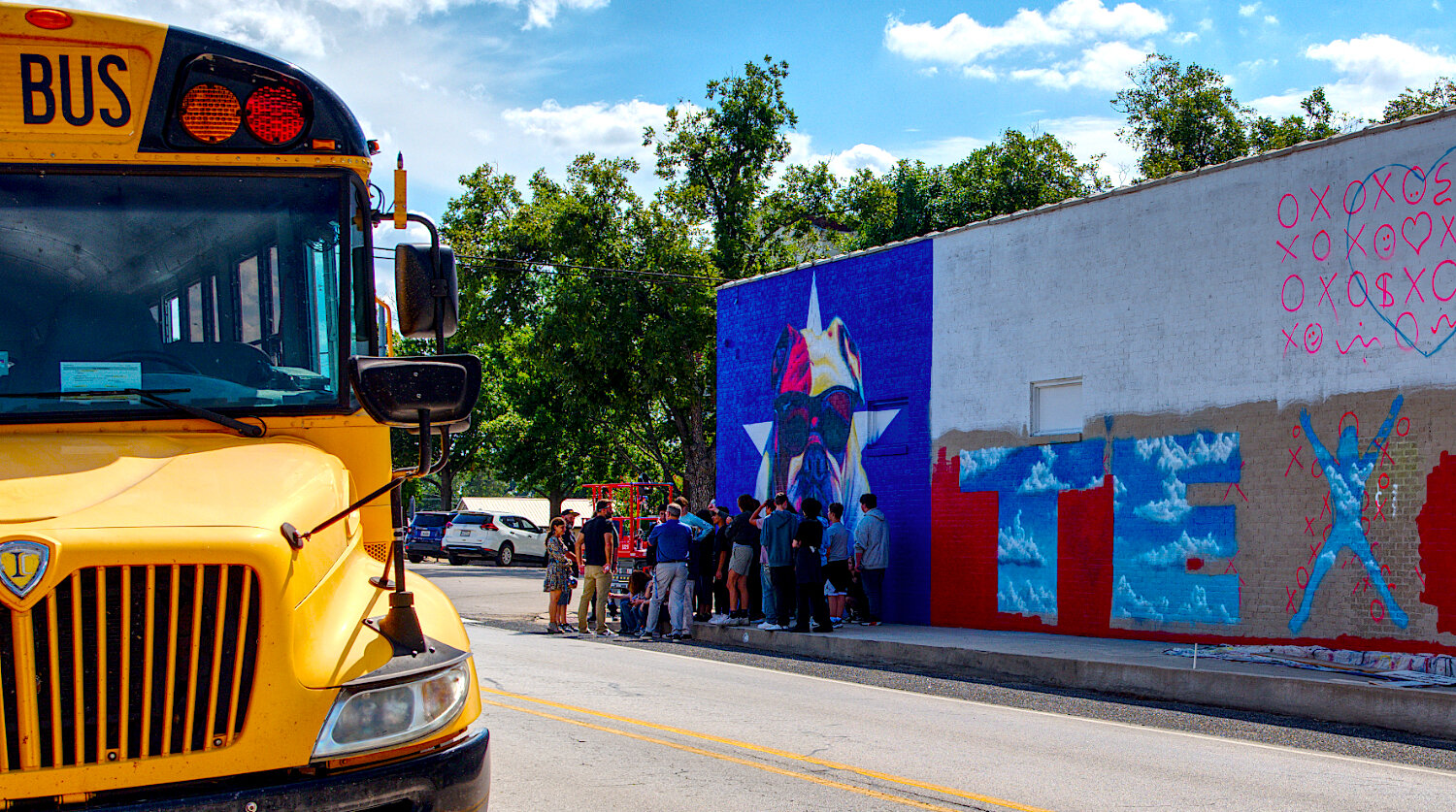 Quitman art students took a bus to the square downtown to learn from muralist Patrick McGregor, who created the art along the west-facing wall of Dani's Sidekick. [see the progression of murals]